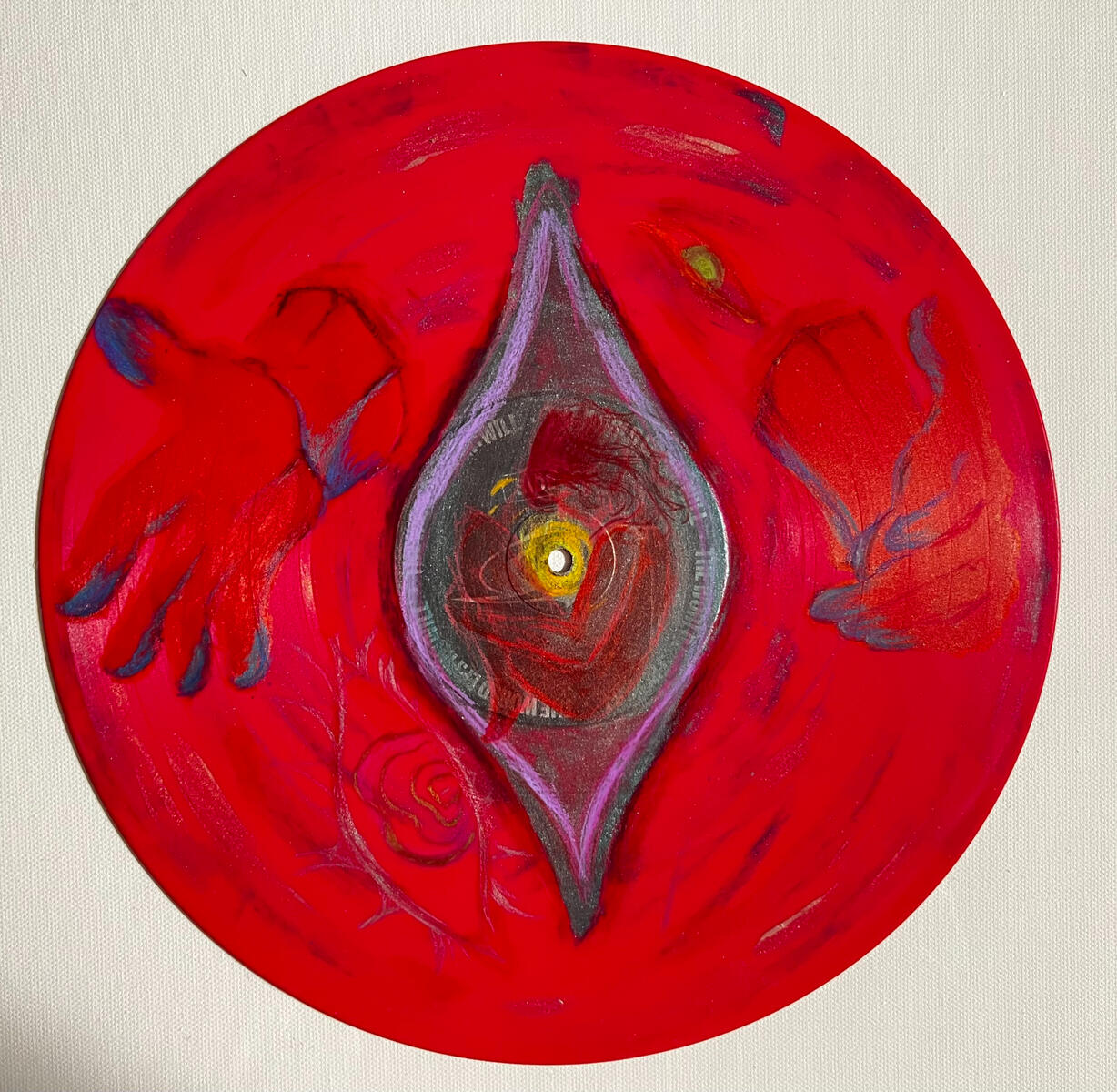 A red vinyl record depicting two hands and multiple eyes surrounding a figure in the center